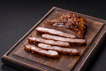Juicy pork steak baked on the grill with salt, spices and herbs