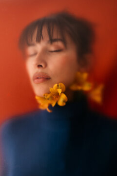Dreamy woman with flowers on neck