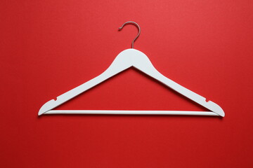 Wooden clothes hanger on a colored background