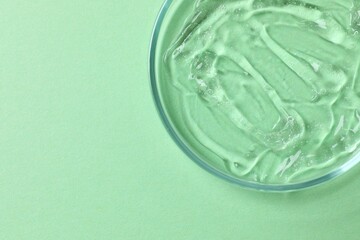 Petri dish, cosmetic gel swatches  on color background, copy space. Bio science research, biochemistry, organic skin care concept