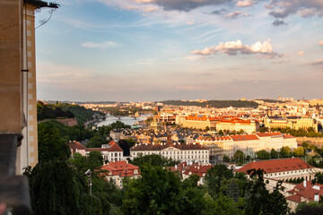 A breathtaking view from Prague Castle capturing the sunset over the Vltava River and cityscape.
