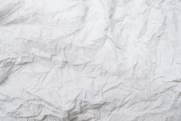 Crumpled white paper background.