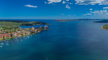 Aerial View of Manly Beach and Sydney harbour with manly houses on a warm summer day blue skies Sydney NSW Australia