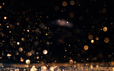 Obraz premium Shimmering dust particles create a magical atmosphere against a dark background