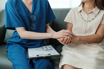 A woman in a white dress is being comforted by a woman in a blue uniform