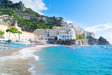 Amalfi old town and summer beach with umbrellas , Italy