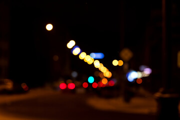 Pattern of glowing multicolored lights on a dark background. Abstraction