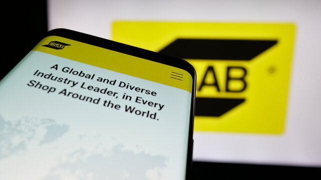 Stuttgart, Germany - 11-07-2024: Smartphone with website of industrial company ESAB Corporation on screen in front of business logo. Focus on top-left of phone display.