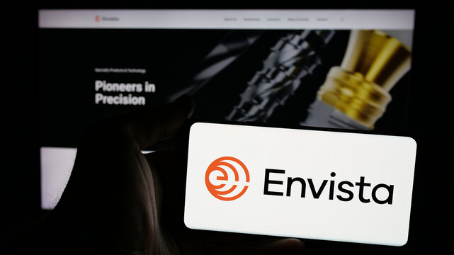 Stuttgart, Germany - 11-07-2024: Person holding mobile phone with logo of US dental care company Envista Holdings Corporation on screen in front of web page. Focus on phone display.