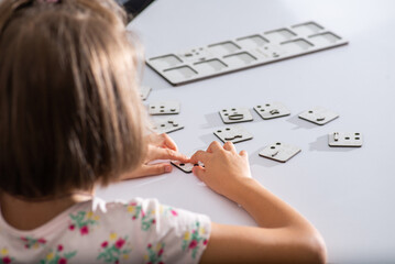 Little child touches with fingers punctuation mark in Braille