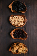 dried fruits and nuts on wooden background, flat lay