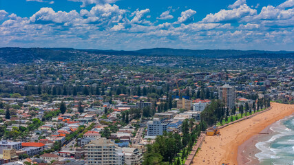 Aerial View of Manly Beach and Sydney harbour with manly houses on a warm summer day blue skies Sydney NSW Australia