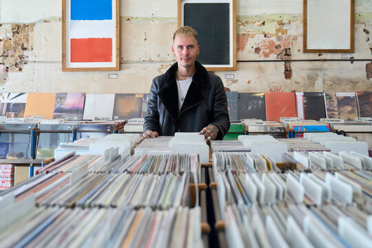 Man exploring a collection of vinyl records in record store