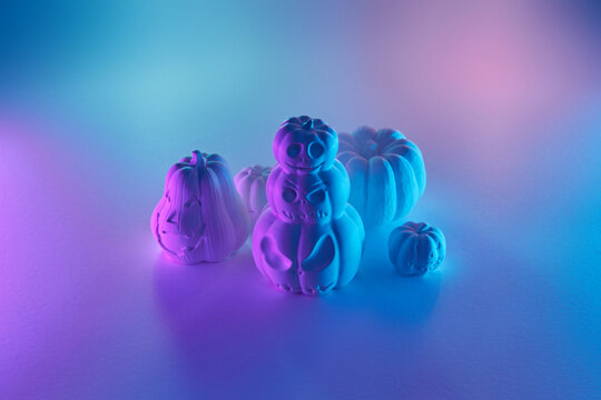 White Halloween pumpkin sculptures in neon light