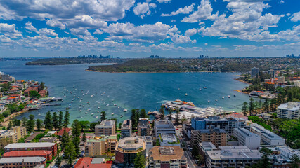 Aerial View of Manly Beach and Sydney harbour with manly houses on a warm summer day blue skies Sydney NSW Australia