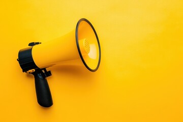 Bright yellow megaphone resting on a vibrant yellow background for effective communication