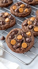 Decadent chocolate cookies feature a caramel drizzle and chocolate chips, beautifully arranged on a wire rack for display