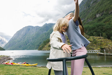 Two girls on a rotating swing