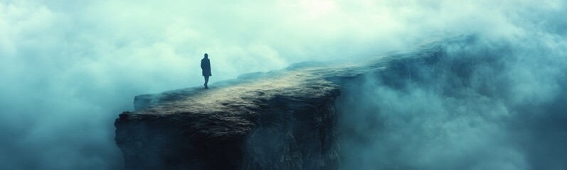 Man standing on a cliff with a sky background