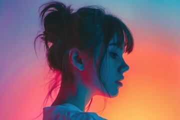 A woman sits with her eyes closed, wearing a hair bun