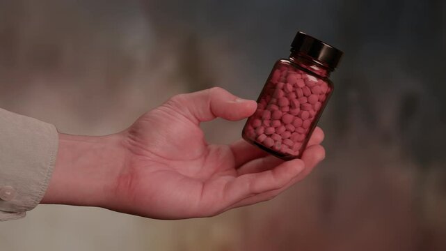 Generic prescription drugs on table top as macro camera moves slowly accross spilled pills and into the bottle. 