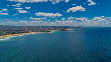 Aerial View of Manly Beach and Sydney harbour with manly houses on a warm summer day blue skies Sydney NSW Australia