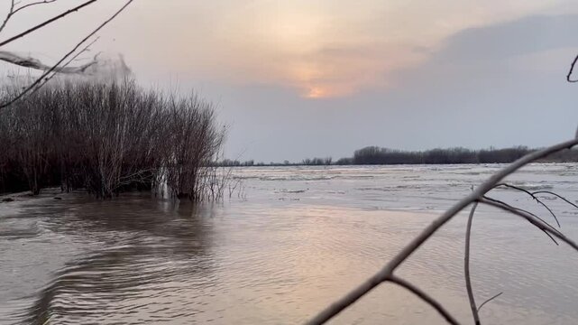 Ice drift on a river in spring during sunset