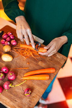 Woman Peels Organic Vegetables for Family Christmas Feast