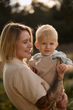portrait of young blonde mom with her little boy 