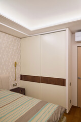 A Modern Bedroom Design Featuring a Chic Builtin Wardrobe Complemented by Cozy Decor