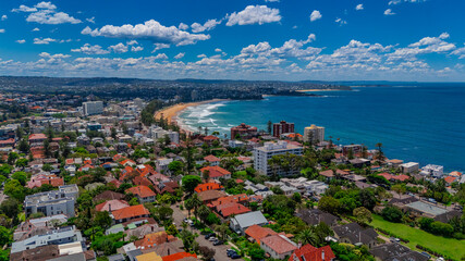 Aerial View of Manly Beach and Sydney harbour with manly houses on a warm summer day blue skies Sydney NSW Australia