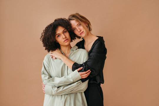 Two Friends Embrace Against a Warm Backdrop