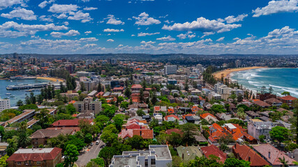 Aerial View of Manly Beach and Sydney harbour with manly houses on a warm summer day blue skies Sydney NSW Australia