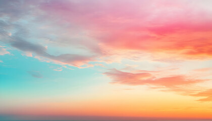 Obraz premium Dreamy pastel sunset sky with soft, colorful clouds. Perfect for backgrounds, websites, and social media.