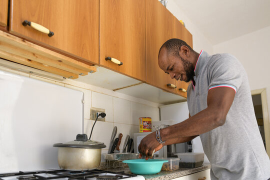 Nigerian man prepares ingredients to cook Banga soup