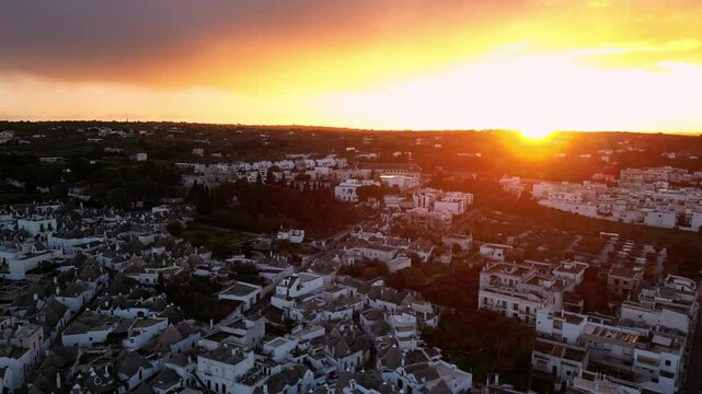 Aerial view of a street among the trulli of Alberobello, in the metropolitan city of Bari in Puglia, Italy.