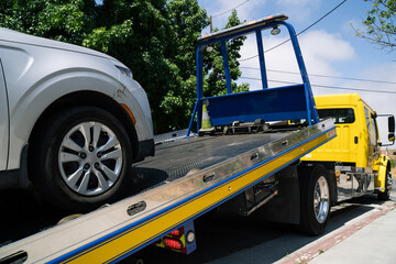 Sliver vehicle loading onto a flatbed tow truck