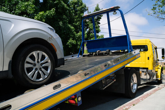 Sliver vehicle loading onto a flatbed tow truck