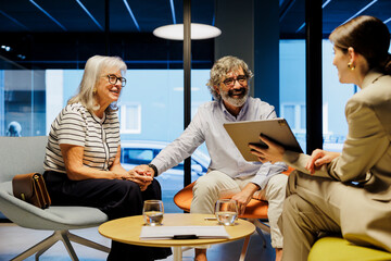 Senior couple smiling while having financial advice meeting