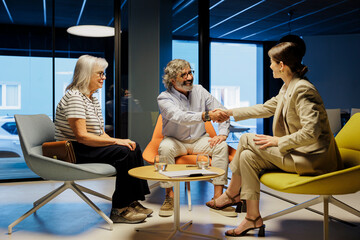 Financial advisor shaking hands with client in meeting