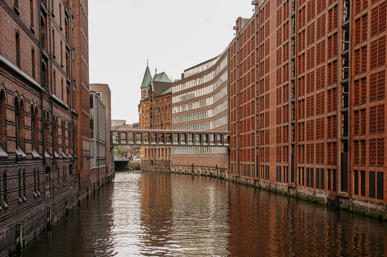 Historic red-brick warehouses along canal in Hamburg Speicherstadt
