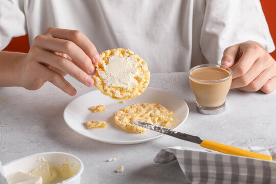 Someone have a breakfast with a puffer corn cake and milk coffee