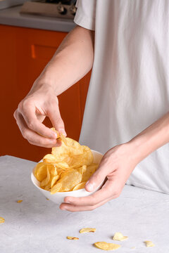 Hand is taking chips from a bowl