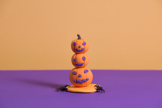 Colorful Halloween Stack of Pumpkins and Spiders on Purple