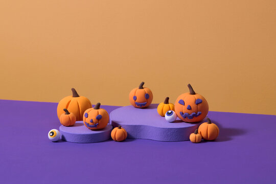 Colorful Halloween Pumpkins and Eyeballs on Purple Background