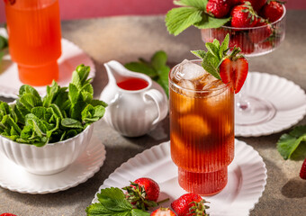 Refreshing strawberry iced tea with fresh mint and ice cubes