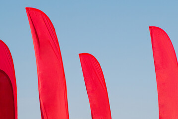 MockUp red flags on the background of blue sky