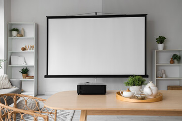 Interior of light room with projector screen and dining table