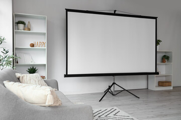 Interior of light room with sofa, shelf units and projector screen