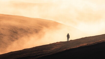 A solitary figure stands on a misty hillside, evoking a sense of tranquility and reflection.